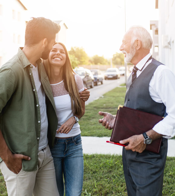 couple standing outside with realtor