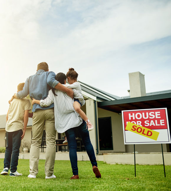 family outside of their new home